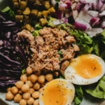Nutritious grain bowl with tuna, soft-boiled eggs, and purple cabbage (1)